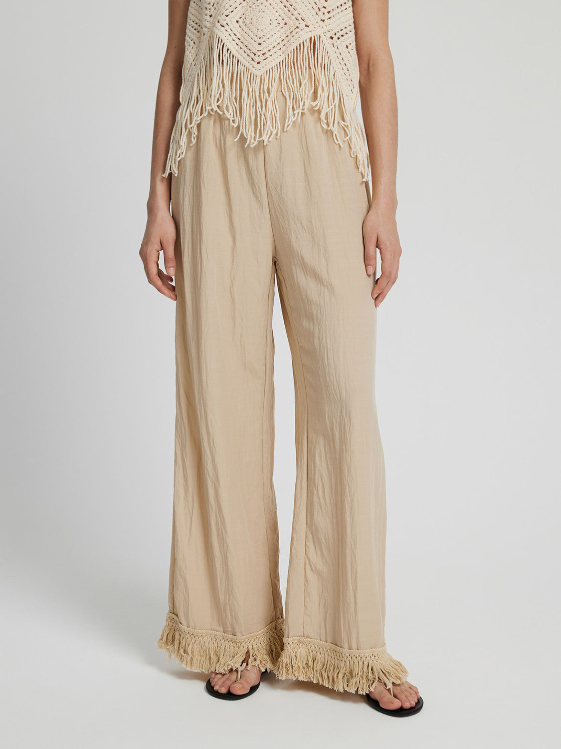 Pantalones largos de pierna ancha con dobladillo con flecos