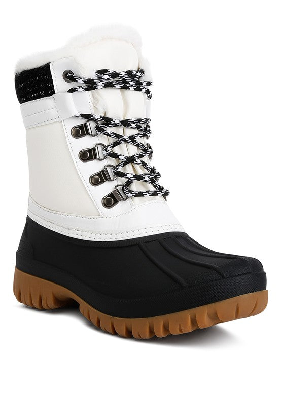Botas con suela dentada en contraste y cuello de piel de Capucine