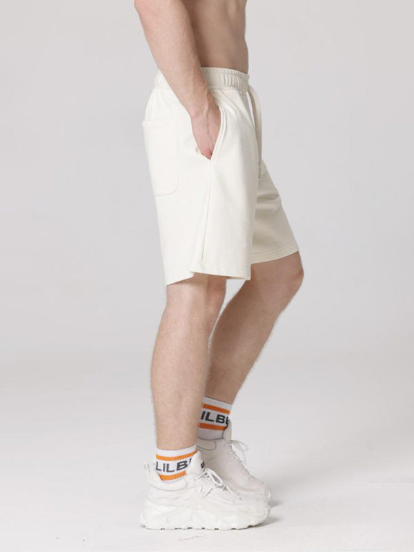 Pantalones cortos deportivos casuales sueltos de color sólido para hombres 